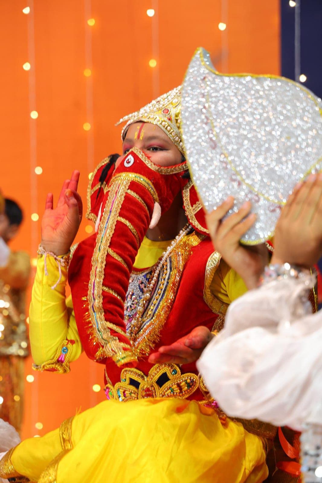 Young child in elaborate costume at the Annual Day performance