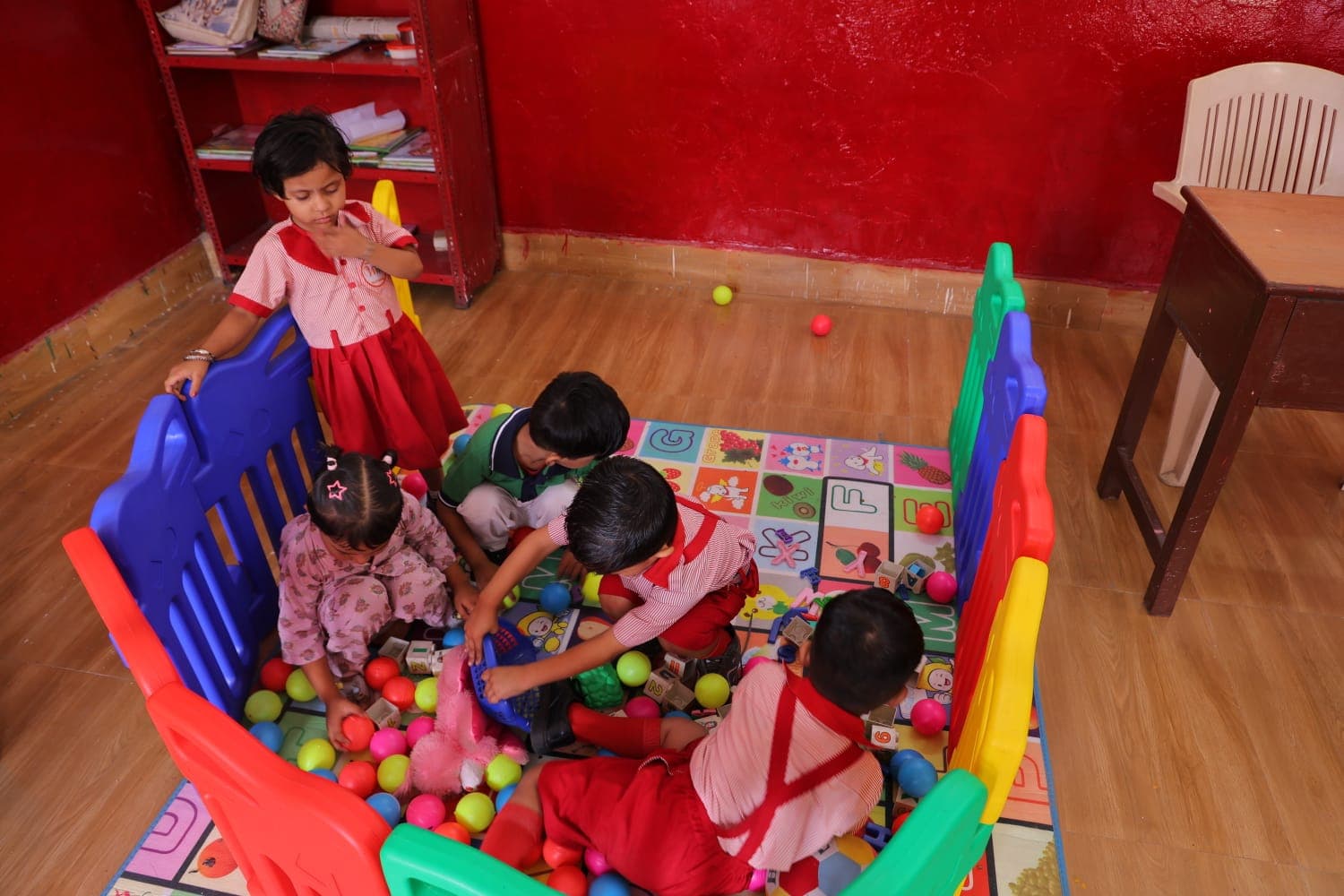 Pre-primary children playing with colourful balls